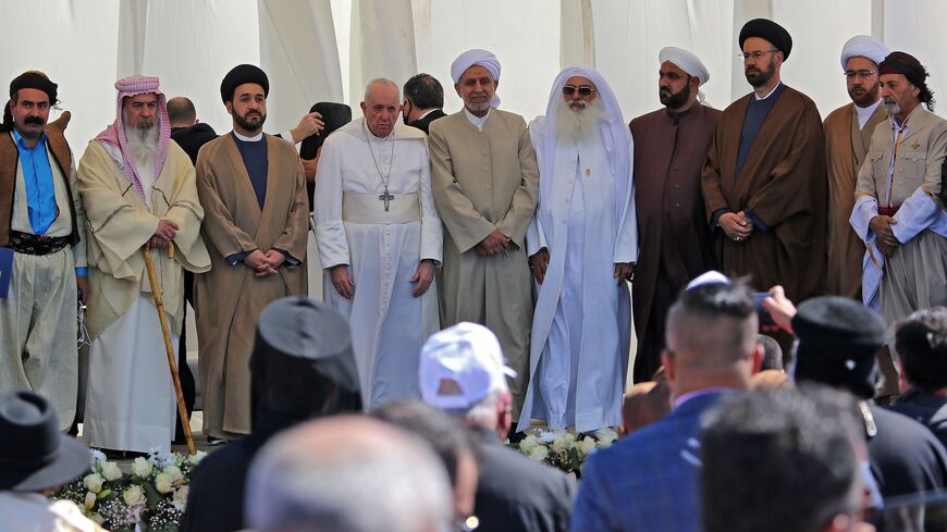 Pope Francis stands with Iraqi religious figures during an interfaith service.