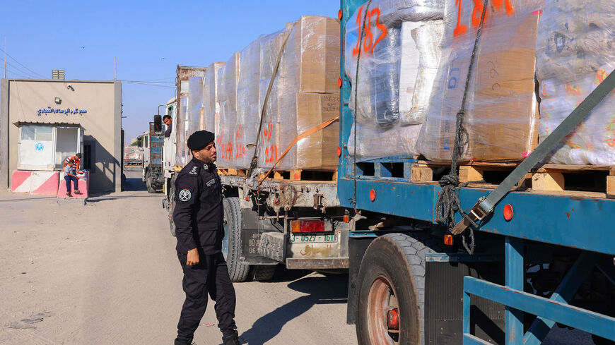 A Palestinian police officer searches a truck's fabrics cargo slated for export at the Kerem Shalom crossing, Rafah, Gaza Strip, June 21, 2021.