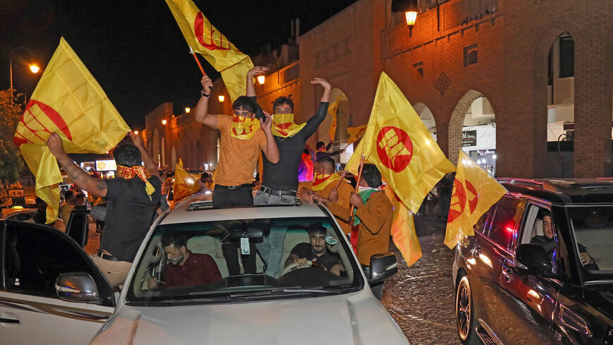 Supporters of the Kurdistan Democratic Party celebrate with the KDP party flags during Iraq's parliamentary election in Erbil, Iraqi Kurdistan, Oct. 10, 2021.