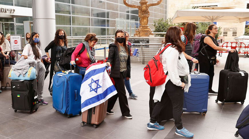 Passengers arriving from the United States walk with their luggage at Ben Gurion International Airport, near Lod, Israel, Nov. 1, 2021.