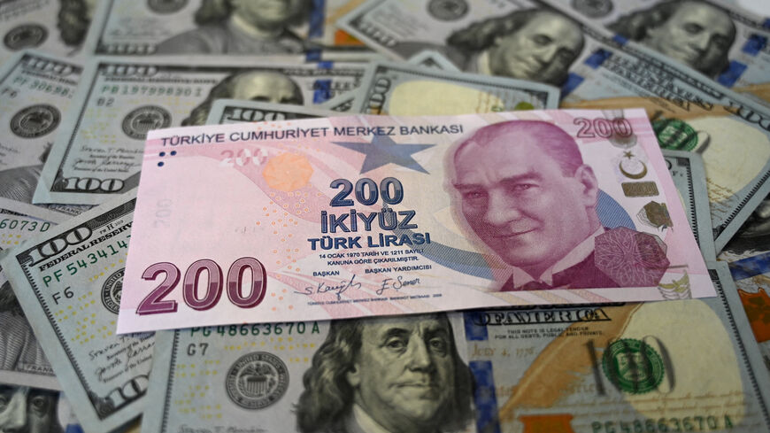 US dollar banknotes and Turkish lira banknotes, photo taken in Istanbul, Turkey, Dec. 7, 2021.