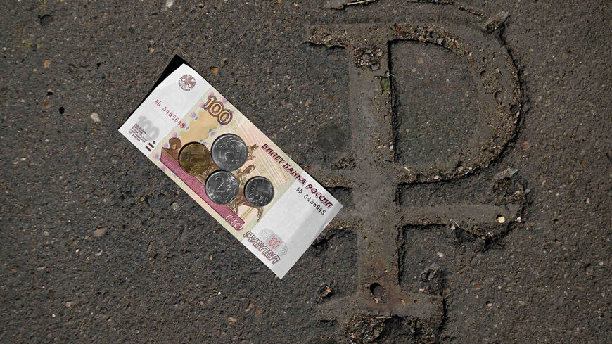 Russian ruble coins and banknote are seen on a Russian ruble sign under construction in downtown Moscow, Russia, June 29, 2022.