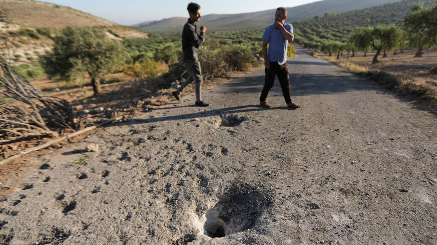 People inspect the site where a US drone strike killed Maher al-Agal, an Islamic State leader, near the village of Khaltan, near Jindayris, northern Syria, July 12, 2022.