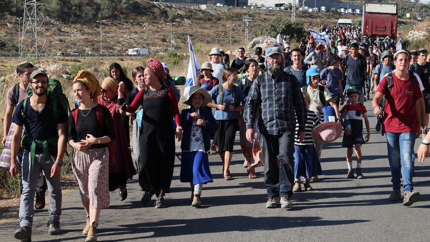 Israeli settlers gather as they try to establish a wildcat settlement outpost.