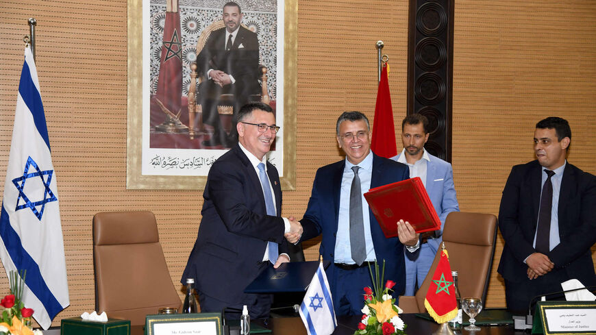 Moroccan Justice Minister Abdellatif Wehbe (R) and Israeli Justice Minister Gideon Saar (L) shake hands after signing an agreement, Rabat, Morocco, July 26 , 2022.