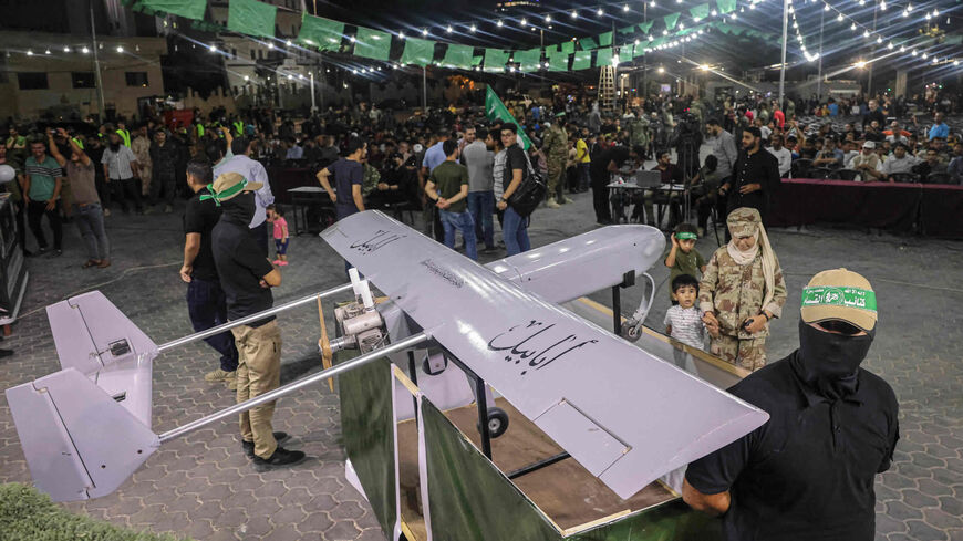 Members of Al-Qassam Brigades, Hamas' military wing, stand next to a model of an Iranian Ababil drone during a rally in the Palestinian town of Khan Yunis, southern Gaza Strip, July 26, 2022.
