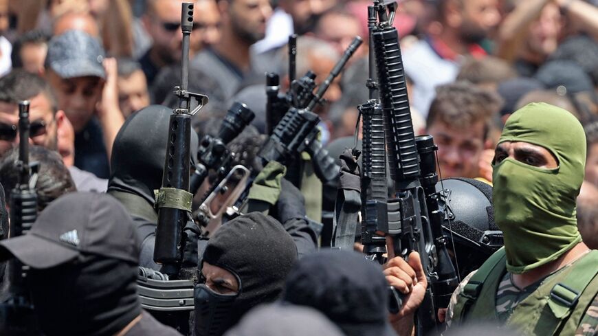 Palestinian militants take part in the funeral procession.