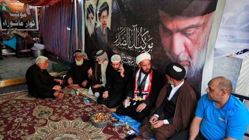Supporters of Iraqi Shiite cleric Muqtada al-Sadr rest during a protest.