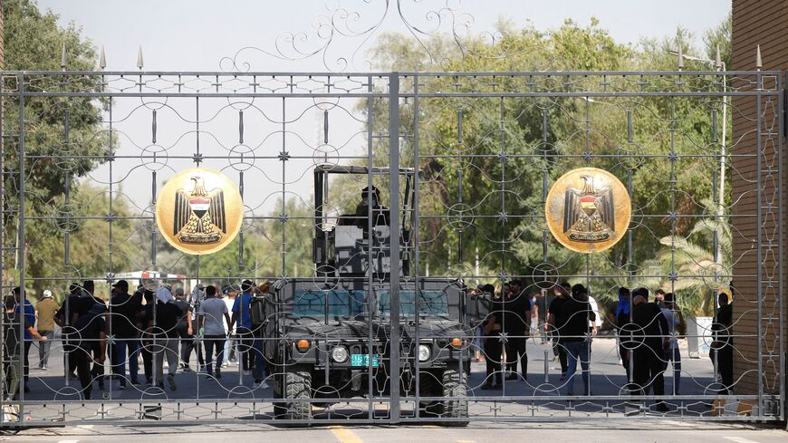 Iraqi police are pictured standing guard at the closed gate of the government headquarters.