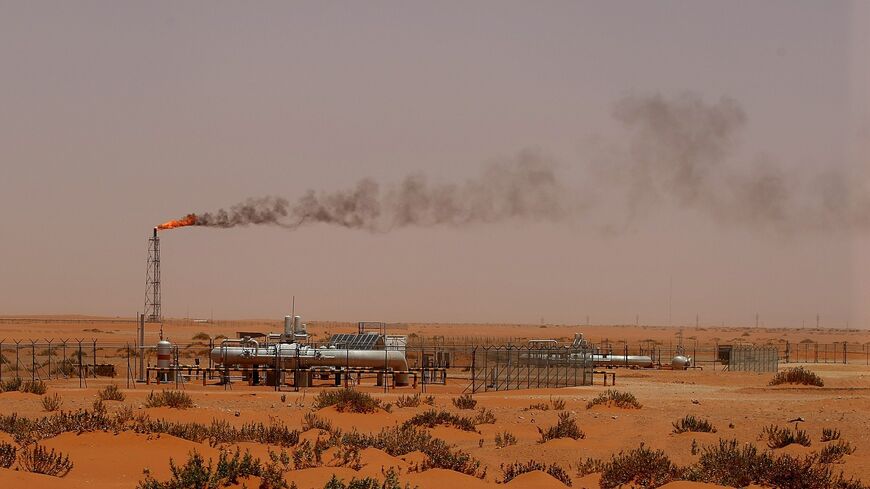 A flame from a Saudi Aramco oil installation known as Pump 3 is seen in the desert near the oil-rich area of Khouris, 160 kilometers east of Riyadh, on June 23, 2008. 