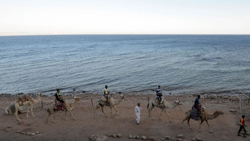 Tourists ride camels on the shores of the town of Dahab, southern Sinai Peninsula, Egypt, May 12, 2017.