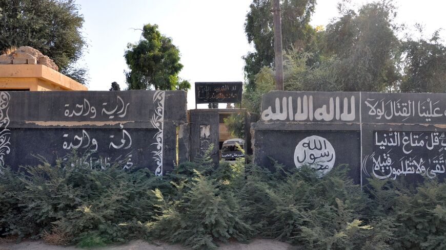 A picture taken on October 20, 2017, shows Islamic State group writing on a wall.