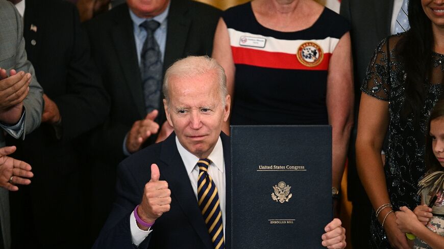 US President Joe Biden gives a thumbs up during a signing ceremony for the PACT Act for veterans exposed to toxic burn pits