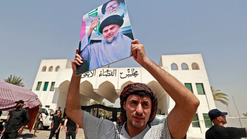 Supporters of Shiite cleric Moqtada Sadr, parade his portrait as they launch a sit-in outside the Baghdad headquarters of Iraq's top judicial body
