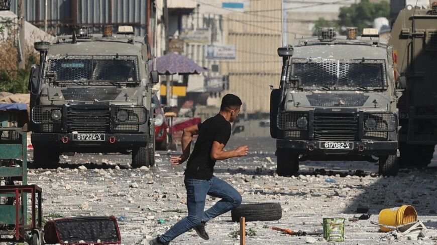 Israeli military vehicles move into the old city of Nablus sparking clashes with Palestinian protesters