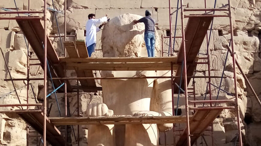 Egypt's Supreme Council of Antiquities restorers and archaeologists restore the statue of King Thutmose II.