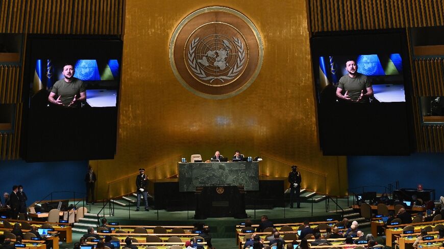 Ukrainian President Volodymyr Zelensky is seen on screen as he remotely addresses the 77th session of the United Nations General Assembly
