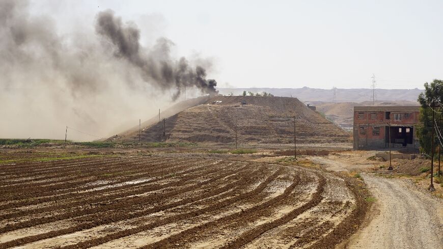 Smoke billows over the village of Altrun Kupri, in the Sherawa region, south of Arbil in Iraq's Kurdistan, where a base of the Kurdistan Freedom Party is located, on September 28, 2022
