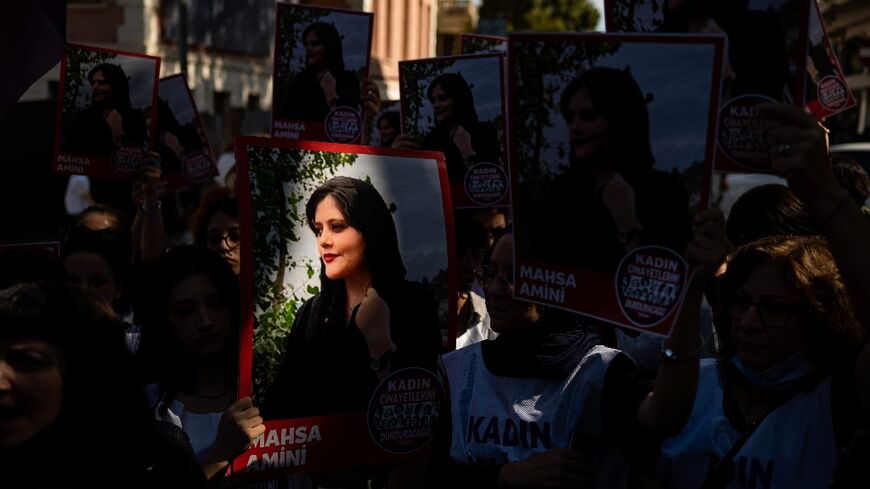 Protestors hold up a picture of 22-year-old Mahsa Amini during a solidarity demonstration outside the Iranian consulate in Istanbul on September 29