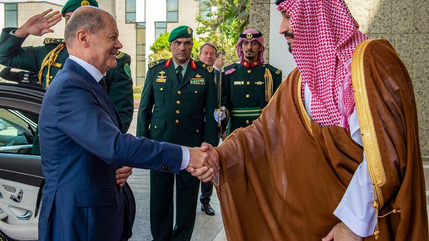 Saudi Crown Prince Mohammed bin Salman (R) shakes hands with Germany's Chancellor Olaf Scholz at al-Salam Palace in the Red Sea coastal city of Jeddah