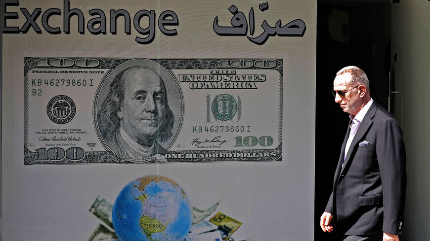 A man walks past a money exchange company, Beirut, Lebanon, Oct. 1, 2019.