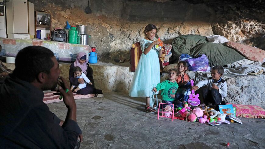 A Palestinian family whose house is located in Area C of the Israeli-occupied West Bank and was demolished by the military sit inside a cave.