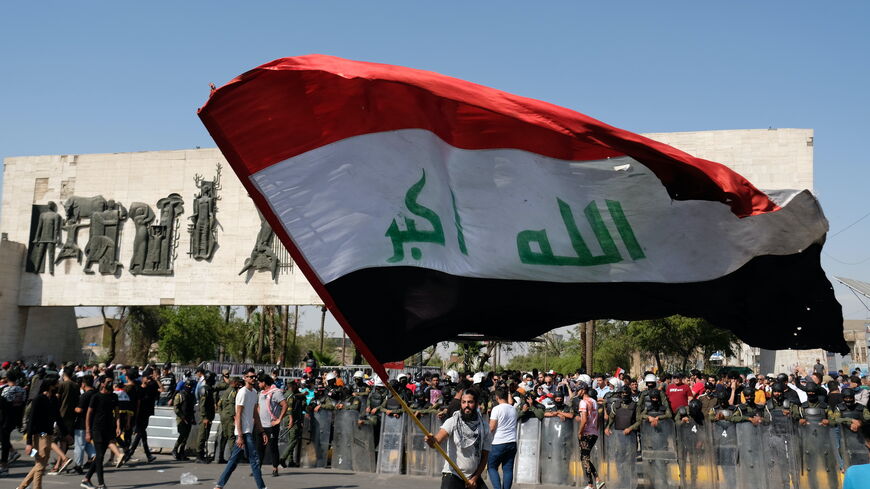 Iraqi protester waving the Iraqi flag in Al Tahrir Square on May 25, 2021 in Baghdad, Iraq. 