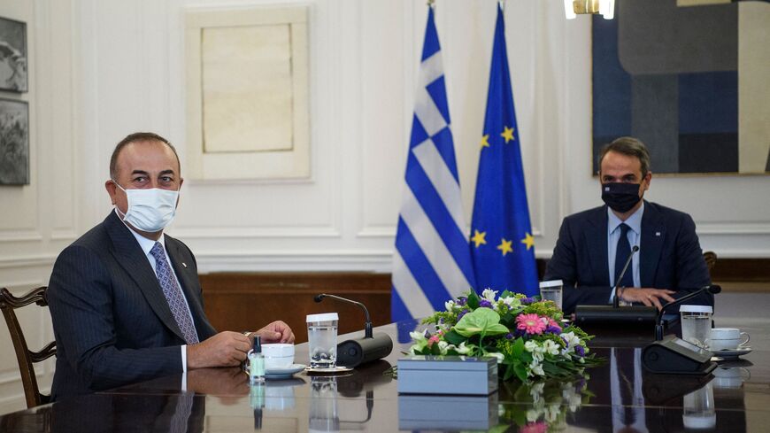 Turkish Foreign Minister Mevlut Cavusoglu (L) meets with Greek Prime Minister Kyriakos Mitsotakis (R) in Athens on May 31, 2021.
