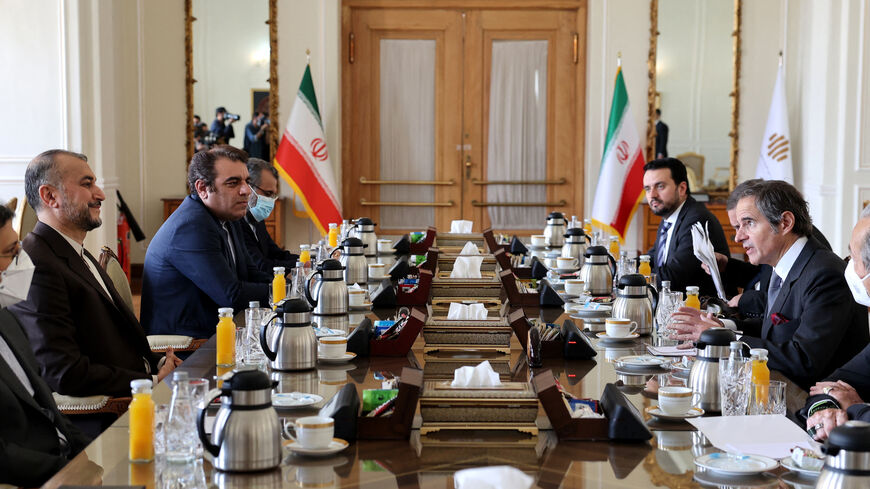 Iranian Foreign Minister Hossein Amir-Abdollahian (L) meets with head of the International Atomic Energy Agency (IAEA) Rafael Grossi (R).