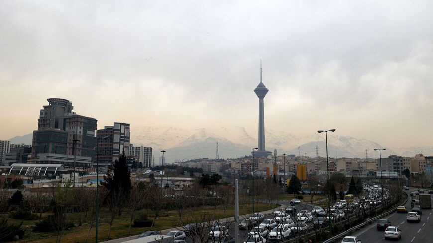 Cars drive on a highway with a backdrop of the Milad telecommunications tower in Iran's capital Tehran on March 12, 2022. - Iran said that US attempts to seize its tankers and oil cargo had failed to stop exports that are subject to sanctions imposed by its arch foe. (Photo by ATTA KENARE / AFP) (Photo by ATTA KENARE/AFP via Getty Images)