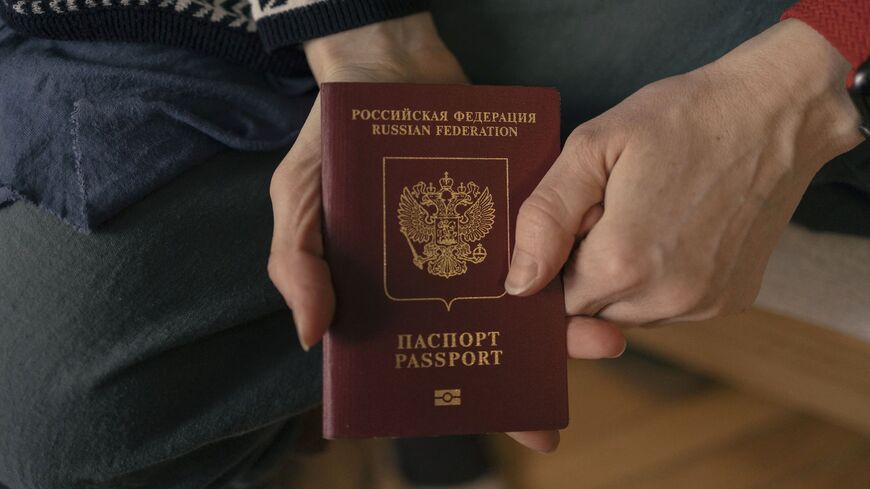 Russian "Marina" shows her Russian passport as she poses for a photo in a hostel in Belgrade, on March 17, 2022.