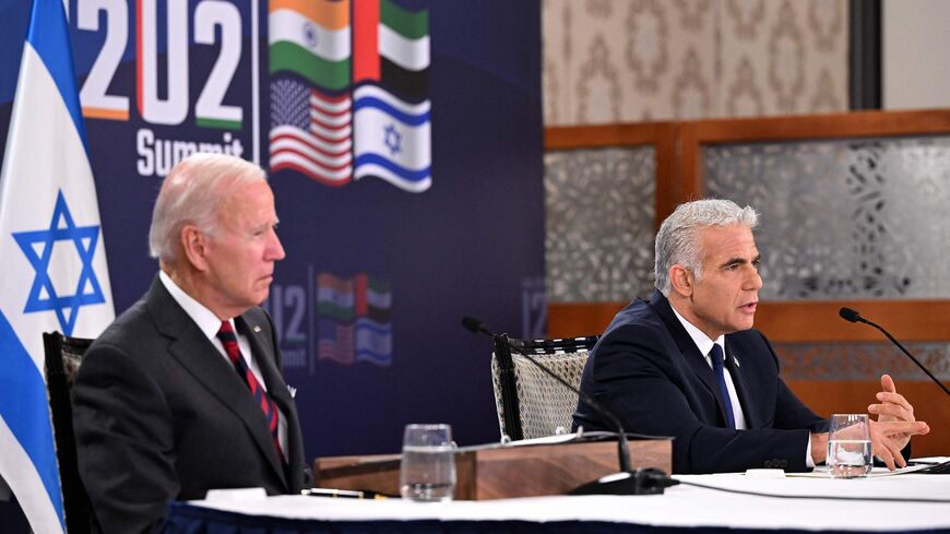 US President Joe Biden (L) and Israel's caretaker Prime Minister Yair Lapid, take part in a virtual meeting with leaders of the I2U2 group, which includes, US, Israel, India, and the United Arab Emirates, at a hotel in Jerusalem, on July 14, 2022. (Photo by MANDEL NGAN / AFP) (Photo by MANDEL NGAN/AFP via Getty Images)