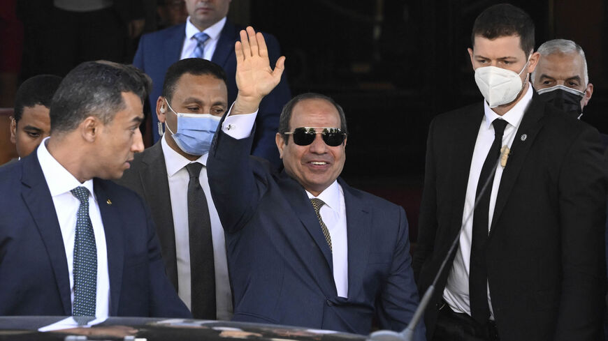 Egyptian President Abdel Fattah al-Sisi waves as he gets out of his hotel in Berlin to leave Germany, after attending the 13th Petersberg Climate Dialogue meeting, July 19, 2022.