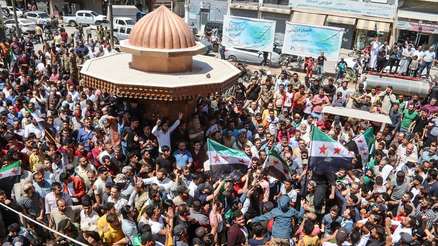 Syrians gather to protest against a proposal from the Turkish foreign minister for reconciliation between the Syrian government and the opposition, in the border town of Azaz in the rebel-held north of Aleppo province, Syria, Aug. 12, 2022.