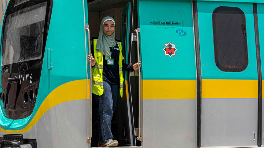 Suzanne Mohamed, an Egyptian female metro train driver, poses at the entrance of a life-size train simulator at Adly Mansour station, Cairo, Egypt, May 31, 2022.