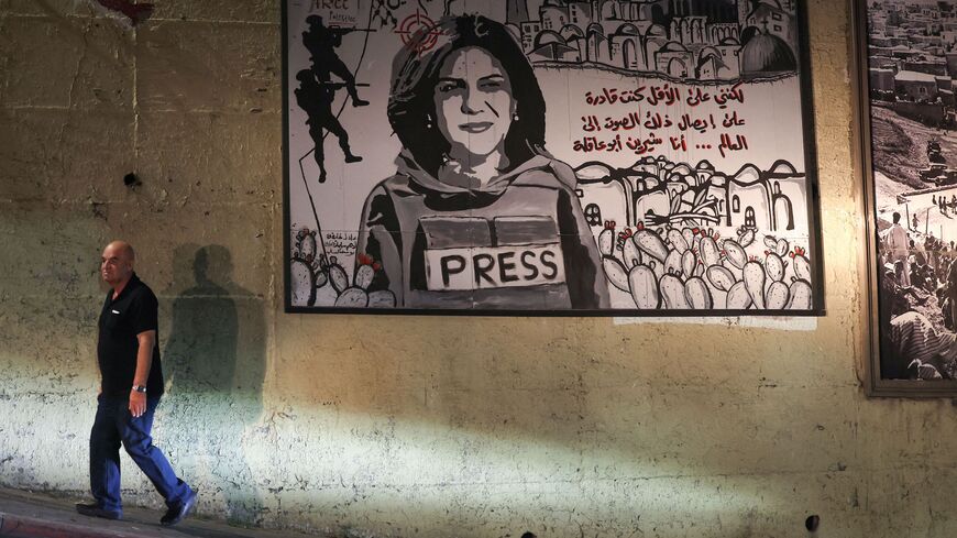 A man walks past a mural depicting slain Palestinian-American journalist Shireen Abu Akleh, on a street in the Arab town of Umm Al-Fahm in northern Israel, on Sept. 5, 2022. 