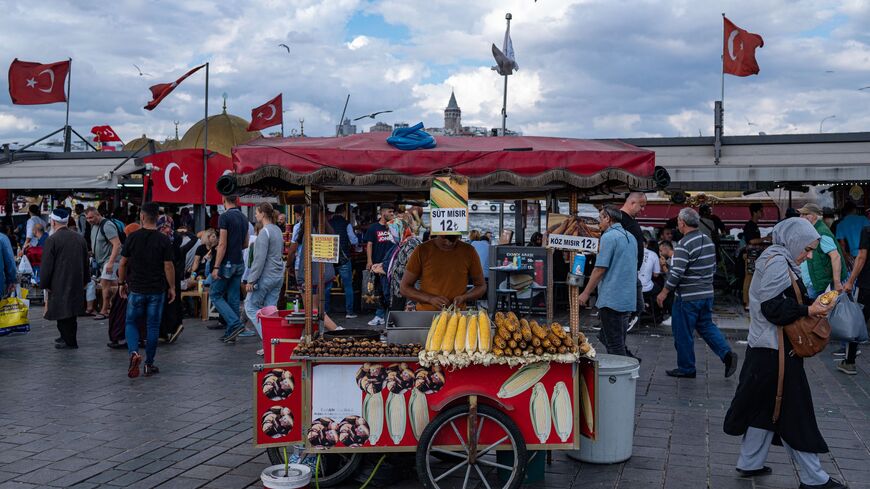 A corn vendor waits for customers on a street in Istanbul on Sept. 6, 2022.