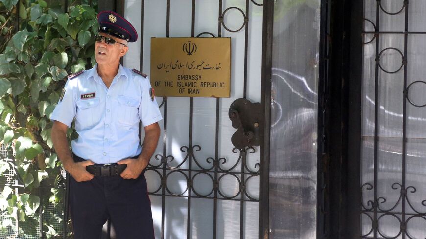 A police officer stands guard outside the Embassy of the Islamic Republic of Iran in Tirana on Sept. 7, 2022.