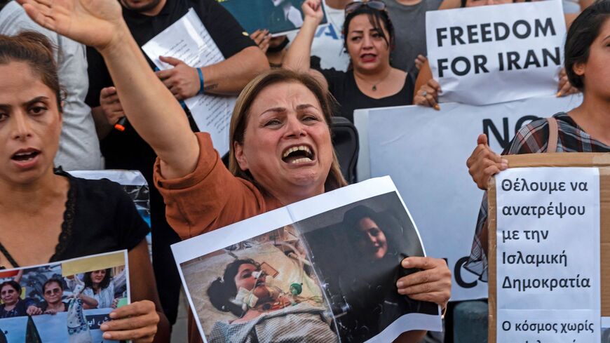 A woman reacts as she takes part in a protest over the death in custody of Mahsa Amini.
