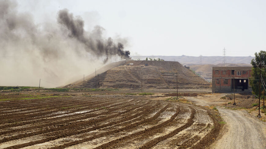 Smoke billows on the horizon in the village of Altrun Kupri, in the Sherawa region, south of Erbil in Iraq's Kurdistan, where a base of the Kurdistan Freedom Party is located, on Sept. 28, 2022.  