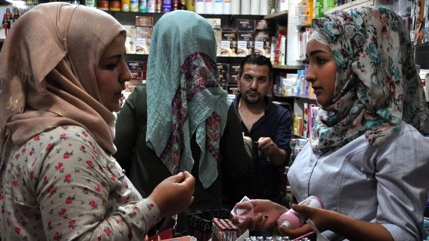 Women buy cosmetics in Syria's northeastern city of Hasakeh on June 12, 2018. 