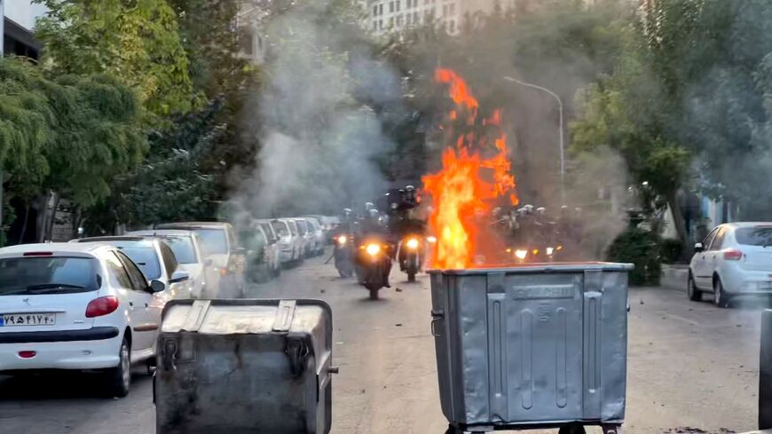 A picture obtained by AFP outside Iran shows a bin burning during a protest in Tehran on September 20, 2022