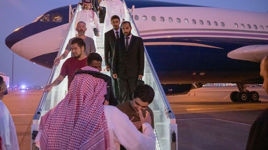 This handout image released by the Saudi Press Agency (SPA) shows foreign prisoners from the Ukraine conflict on arrival in Riyadh from Russia
