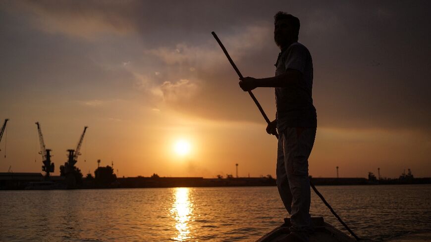 Sun setting on the Tigris: Iraqi fisherman Naim Haddad plys the Shatt al-Arab near Basra