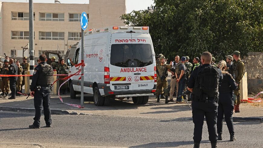 Israeli security forces stand guard at the scene of a stabbing attack in Hebron in the Israeli-occupied West Bank
