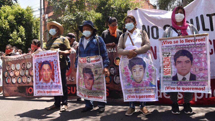 Relatives of 43 Mexican students who disappeared in 2014 protest outside the Israeli embassy in Mexico City to demand the extradition of a fugitive former investigator