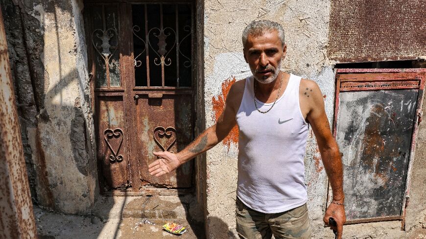 Najib al-Khatib, 52, indicates a place that was laden with corpses after the Sabra and Shatila massacre 40 years ago