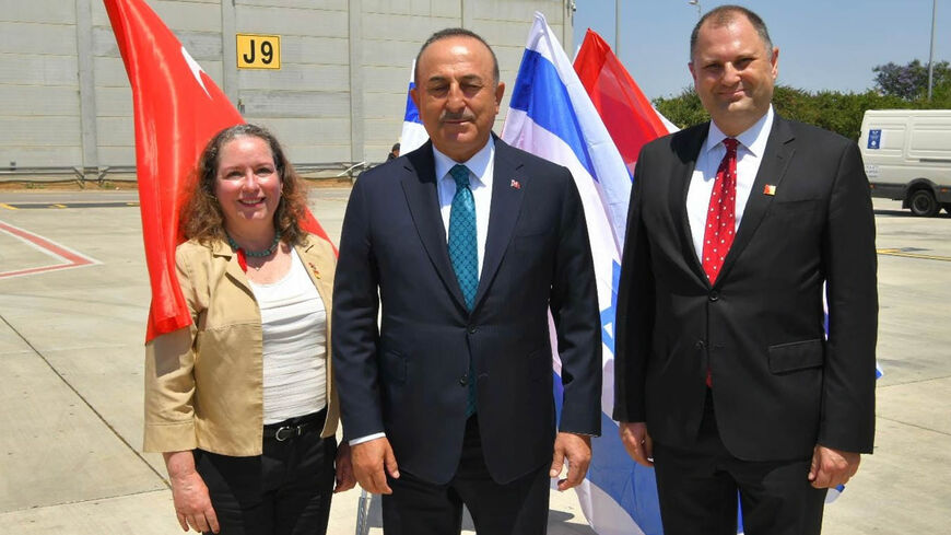 Israeli Charge d'Affaires Irit Lillian is seen with Turkish Foreign Minister Mevlut Cavusoglo (C), Israel, May 2022.