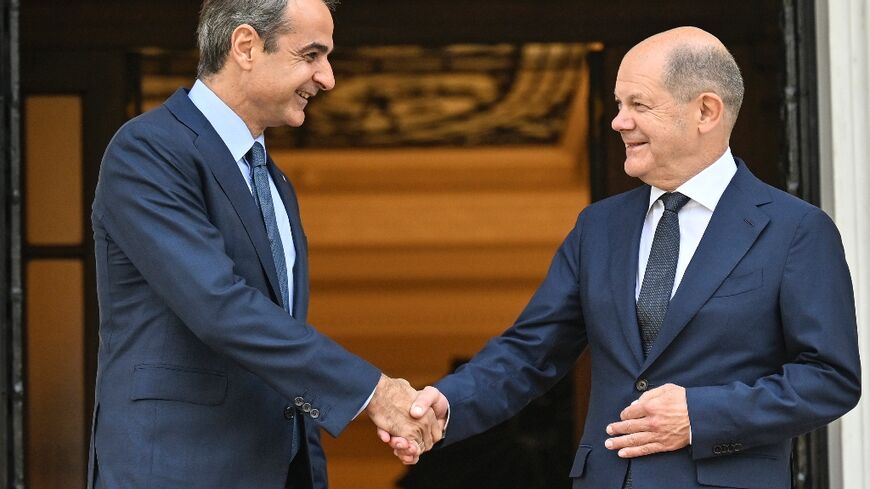 Greek PM Mitsotakis (L) met German Chancellor Scholz (R) on Thursday