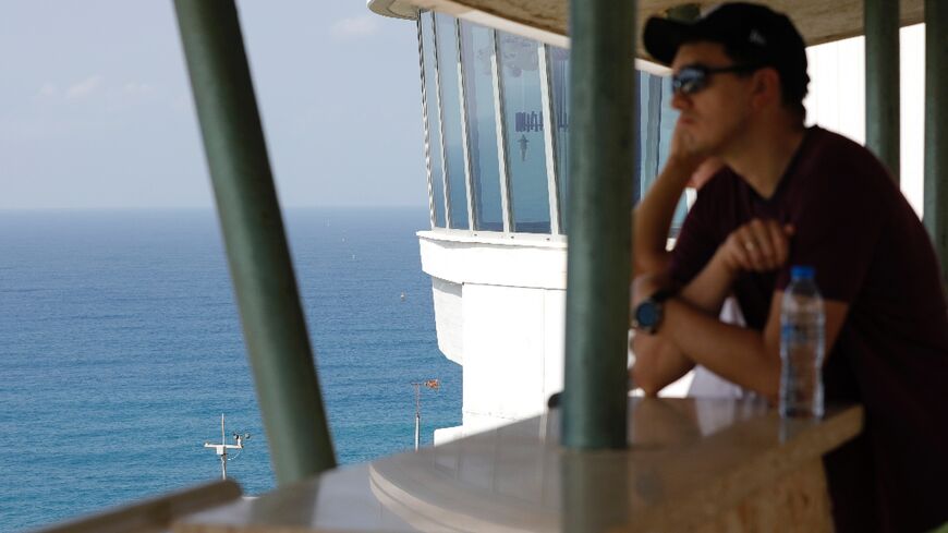 A man looks out to sea towards maritime border markers in Mediterranean waters off Israel's crossing at Rosh Hanikra, known in Lebanon as Ras al-Naqura